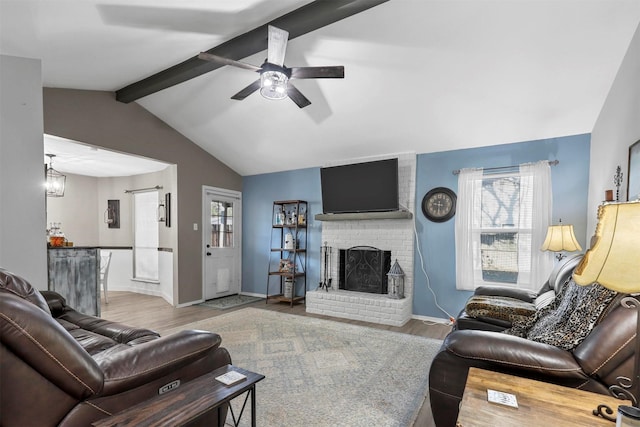 living room with vaulted ceiling with beams, a brick fireplace, ceiling fan, and hardwood / wood-style flooring