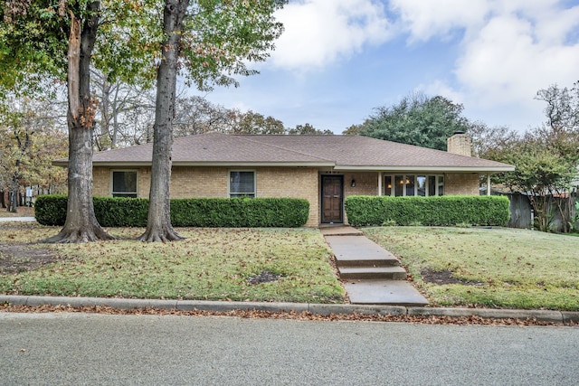 ranch-style home with a front lawn