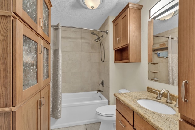 full bathroom featuring tile patterned floors, toilet, a textured ceiling, vanity, and shower / bath combo with shower curtain