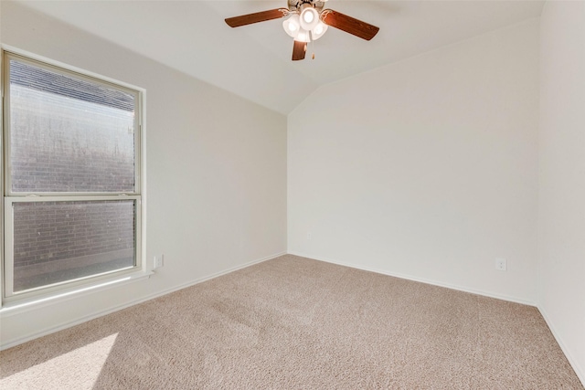 carpeted empty room with vaulted ceiling and ceiling fan