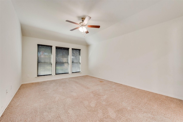 carpeted spare room with lofted ceiling and ceiling fan