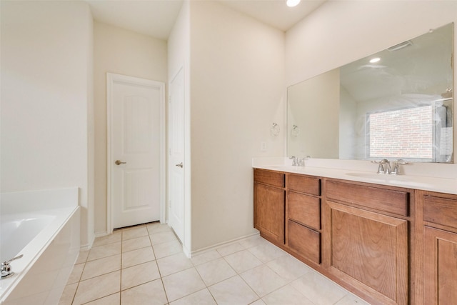 bathroom featuring tile patterned flooring, vanity, and a bathing tub