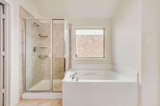 bathroom featuring vaulted ceiling, separate shower and tub, and tile patterned floors