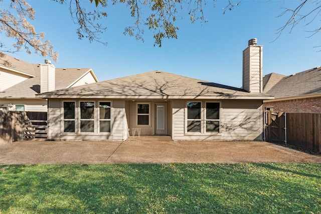 rear view of property featuring a patio area and a lawn