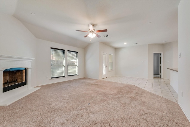 unfurnished living room with light colored carpet and ceiling fan