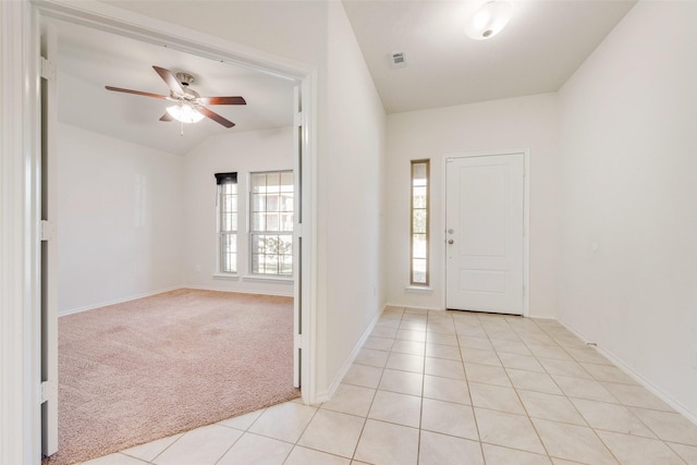 carpeted foyer entrance featuring vaulted ceiling and ceiling fan