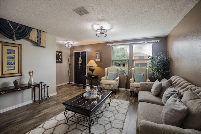 living room featuring a textured ceiling and dark hardwood / wood-style flooring