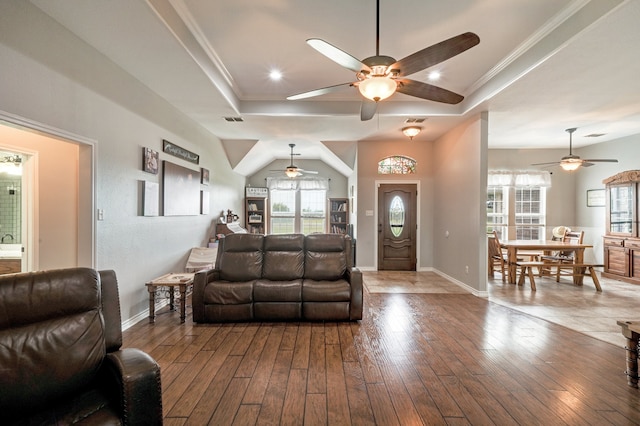 living room with ornamental molding, wood-type flooring, and a tray ceiling