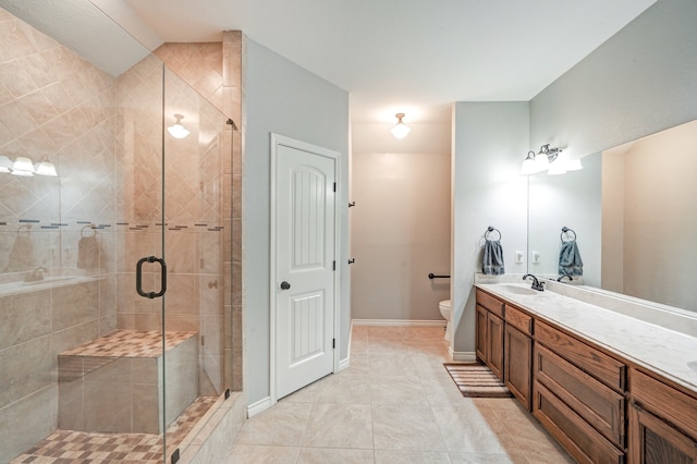 bathroom featuring vanity, a shower with shower door, tile patterned floors, and toilet