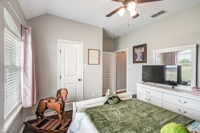 bedroom featuring hardwood / wood-style flooring, vaulted ceiling, and ceiling fan