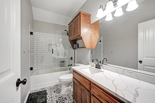 full bathroom with tile patterned flooring, vanity, shower / bath combination with glass door, and toilet