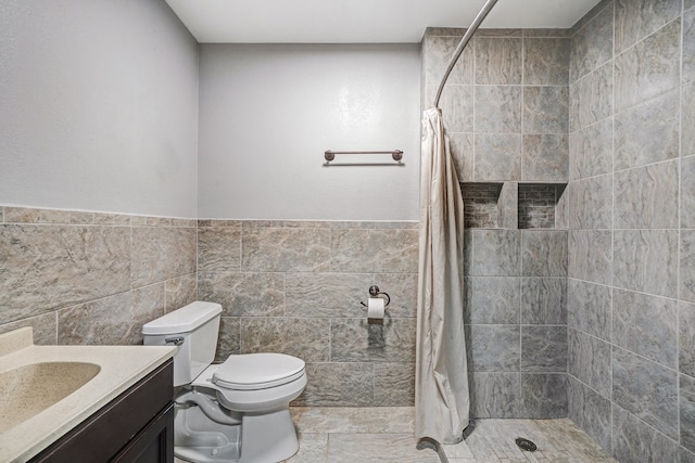 bathroom featuring tile walls, vanity, toilet, and a shower with shower curtain