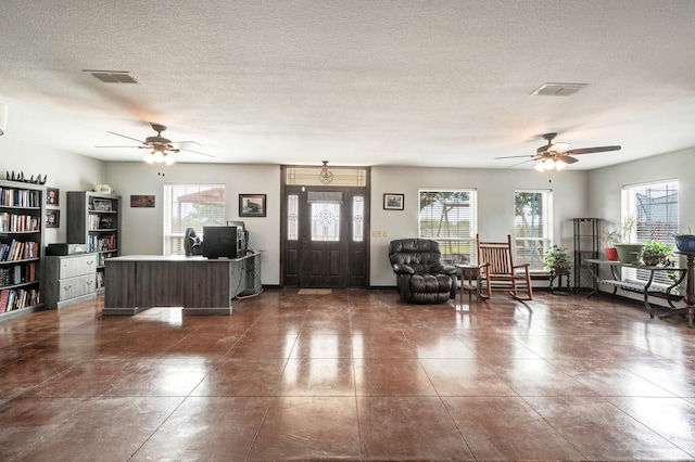 unfurnished living room featuring plenty of natural light and a textured ceiling