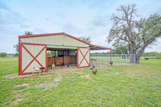 view of outbuilding with a yard and a rural view