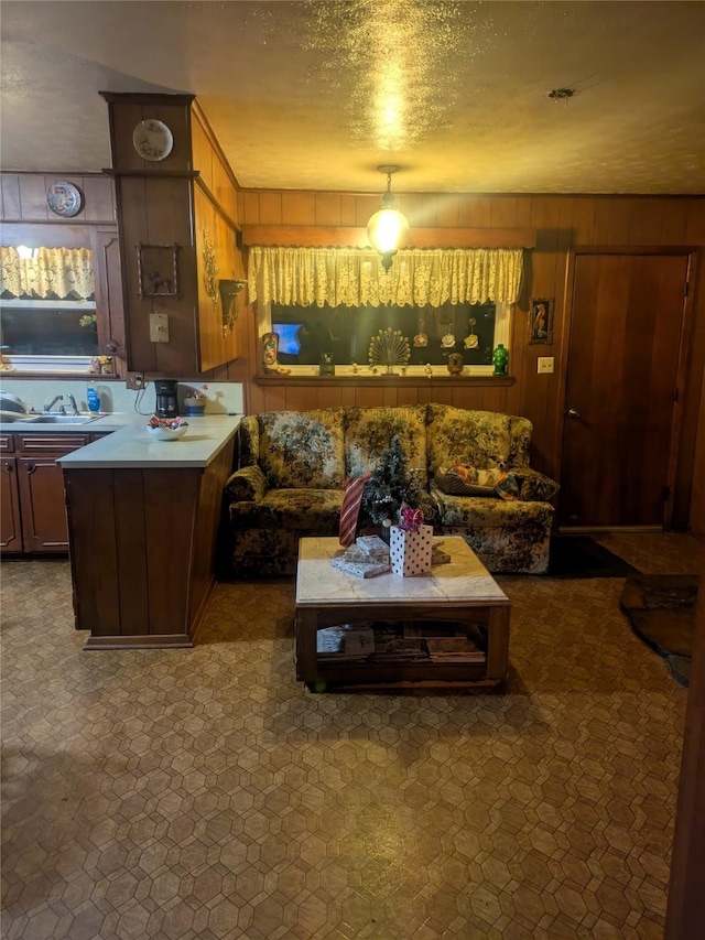 kitchen with a textured ceiling and wooden walls