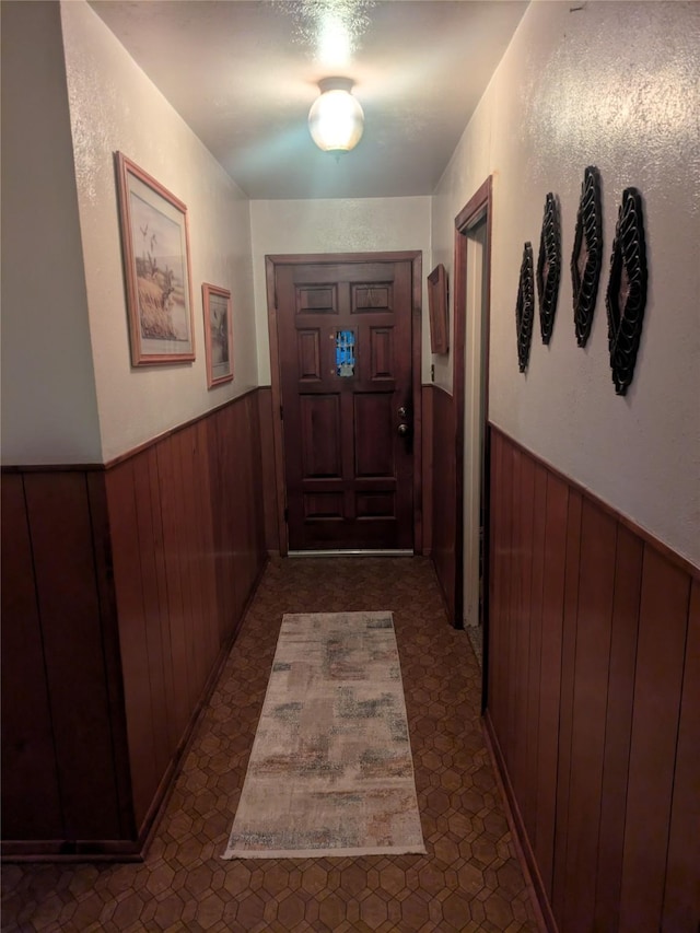 entryway with wooden walls