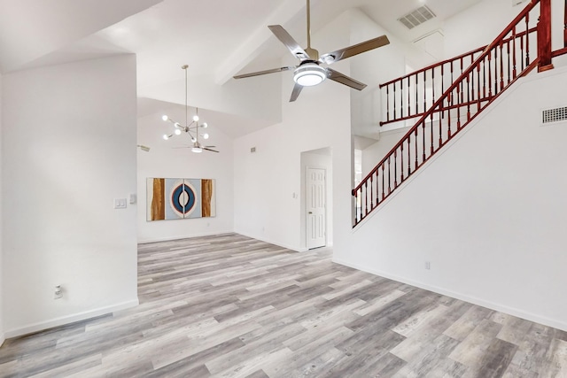 unfurnished living room featuring beamed ceiling, light hardwood / wood-style flooring, high vaulted ceiling, and ceiling fan with notable chandelier