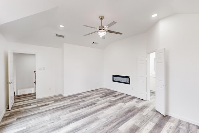 unfurnished living room with ceiling fan, light hardwood / wood-style floors, and lofted ceiling