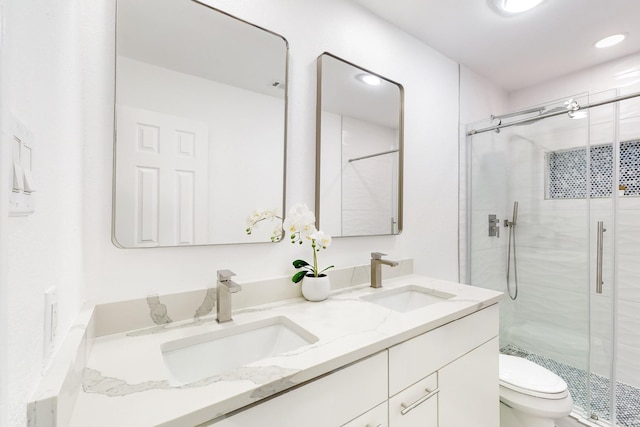 bathroom with vanity, toilet, and walk in shower