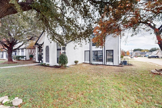 view of side of home with a lawn