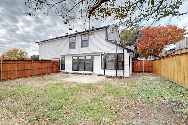 rear view of house with a yard