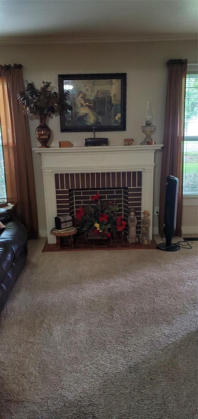 living room with a fireplace, carpet flooring, and crown molding