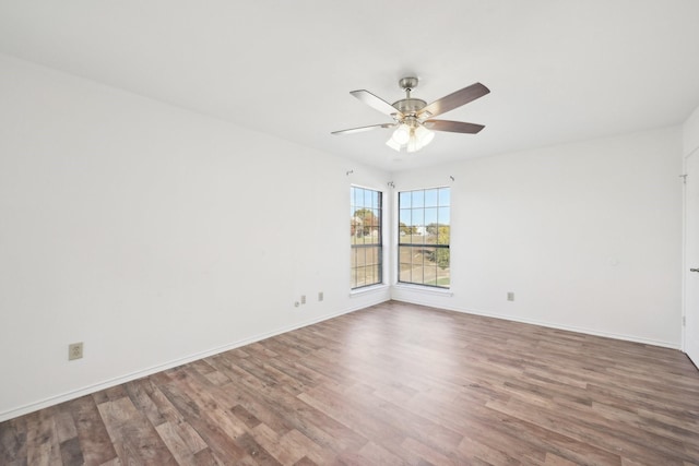 spare room with ceiling fan and wood-type flooring