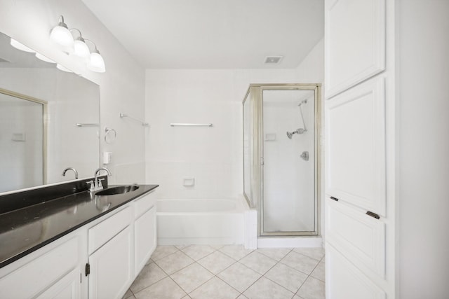 bathroom with tile patterned floors, separate shower and tub, and vanity