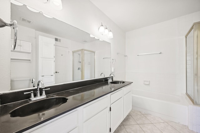 full bathroom featuring plus walk in shower, vanity, tile patterned floors, and toilet