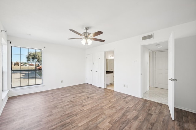 spare room featuring ceiling fan and light wood-type flooring