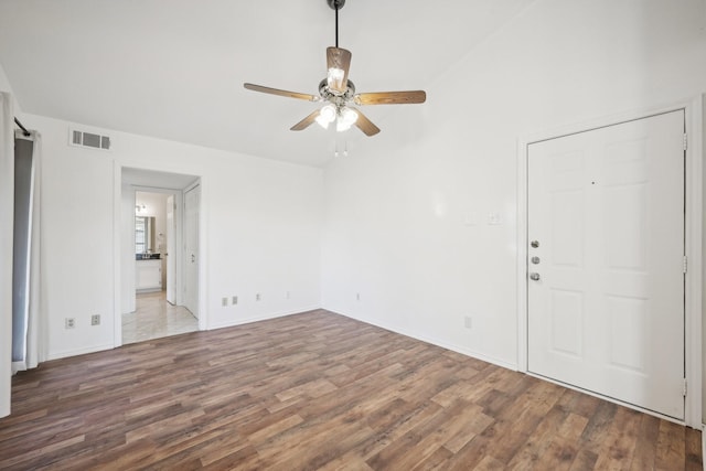 unfurnished room with ceiling fan and dark hardwood / wood-style flooring