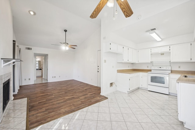 kitchen with ceiling fan, high vaulted ceiling, white range with electric stovetop, light hardwood / wood-style floors, and white cabinets