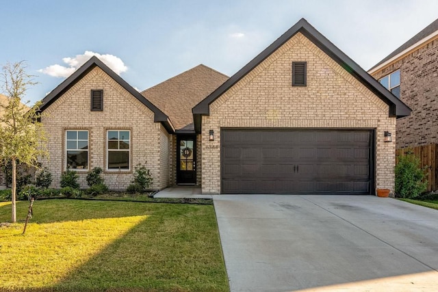 view of front of property with a garage and a front lawn