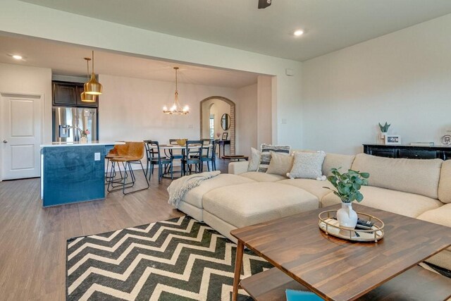 living room featuring light hardwood / wood-style floors and a chandelier