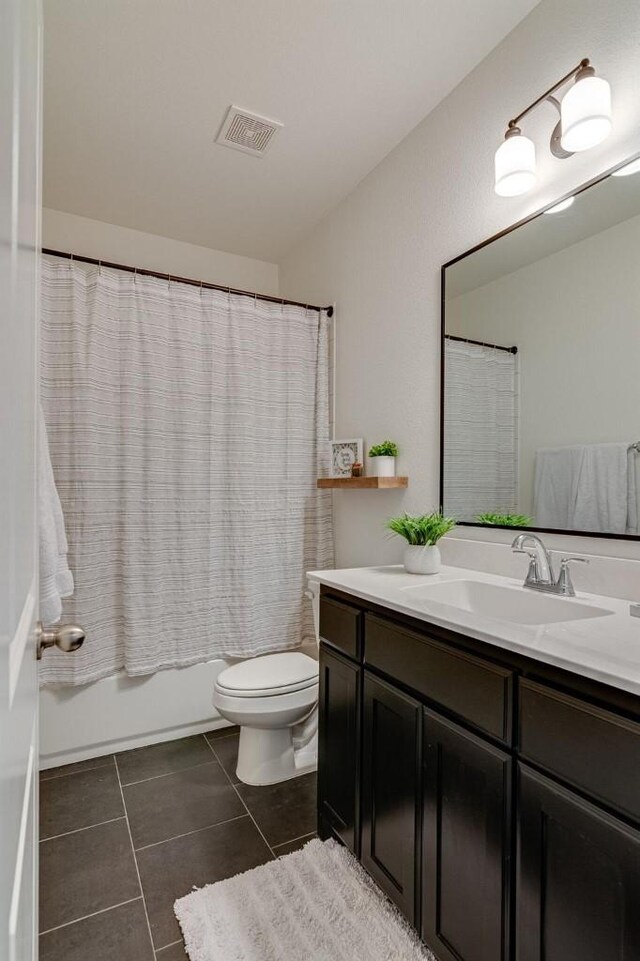 full bathroom with tile patterned floors, vanity, shower / bath combo, and toilet