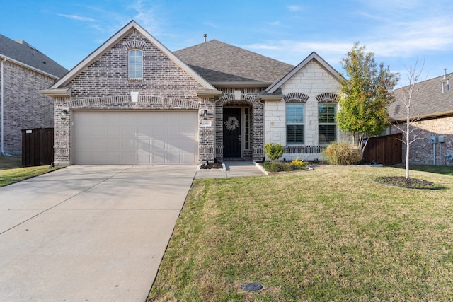 view of front of property with a front yard and a garage