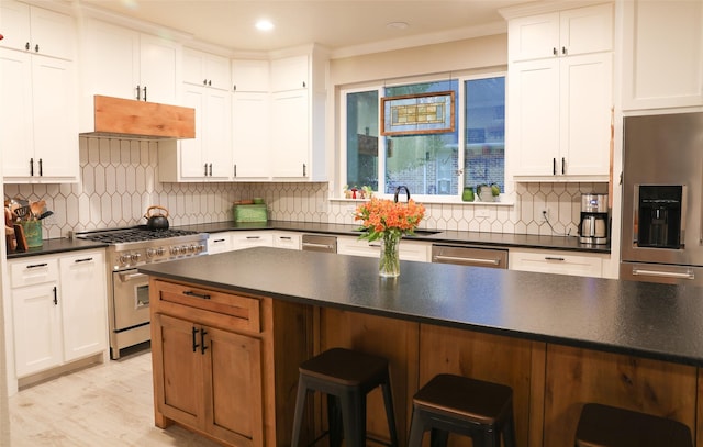 kitchen featuring appliances with stainless steel finishes, sink, and white cabinets