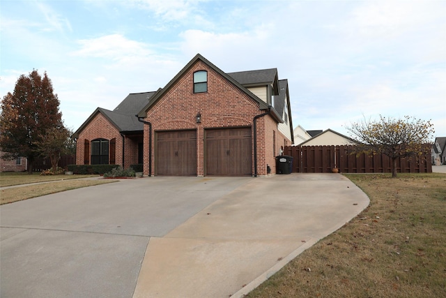 view of front of house with a front lawn and a garage