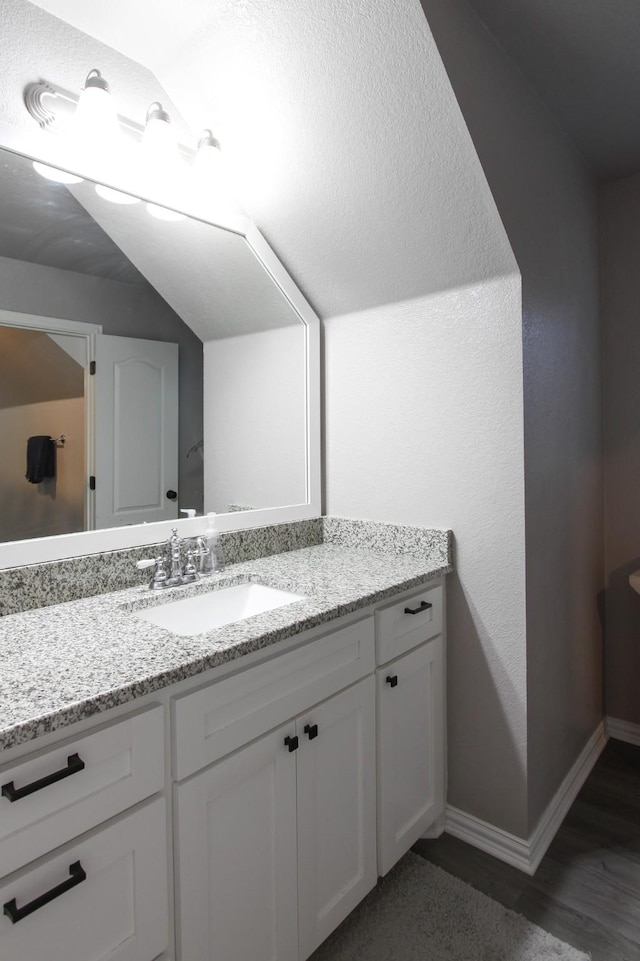 bathroom with vanity and hardwood / wood-style floors