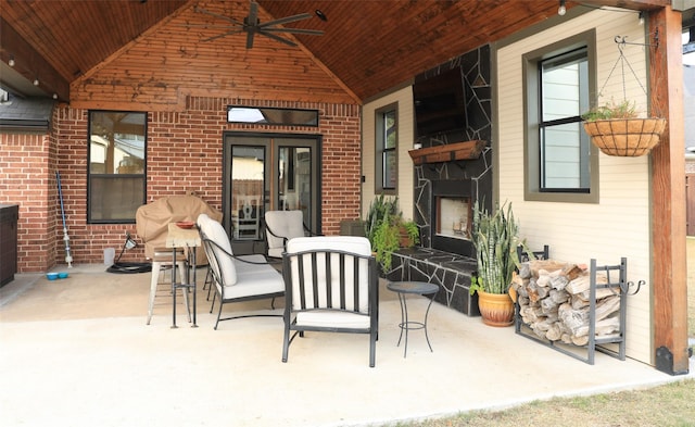 view of patio with area for grilling, an outdoor living space, and ceiling fan