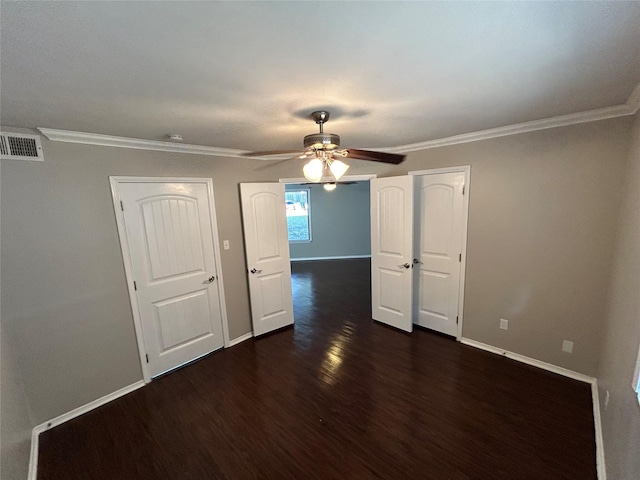 spare room with dark hardwood / wood-style flooring, ceiling fan, and crown molding