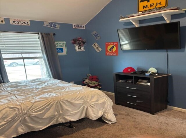 bedroom with lofted ceiling and carpet flooring