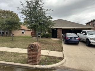 single story home featuring a garage and a front lawn