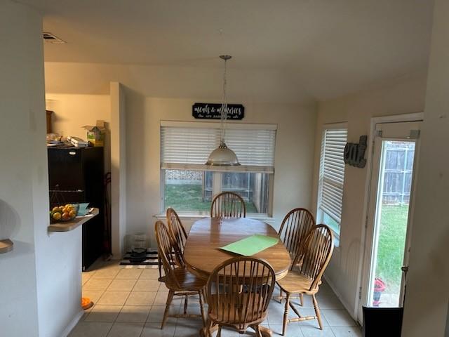 dining area with light tile patterned floors