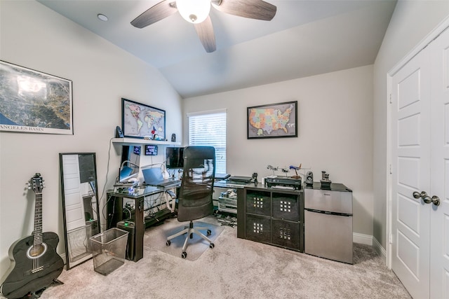 office area featuring ceiling fan, light colored carpet, and vaulted ceiling