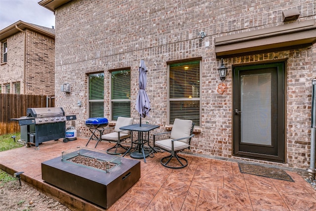 view of patio featuring a grill and a fire pit