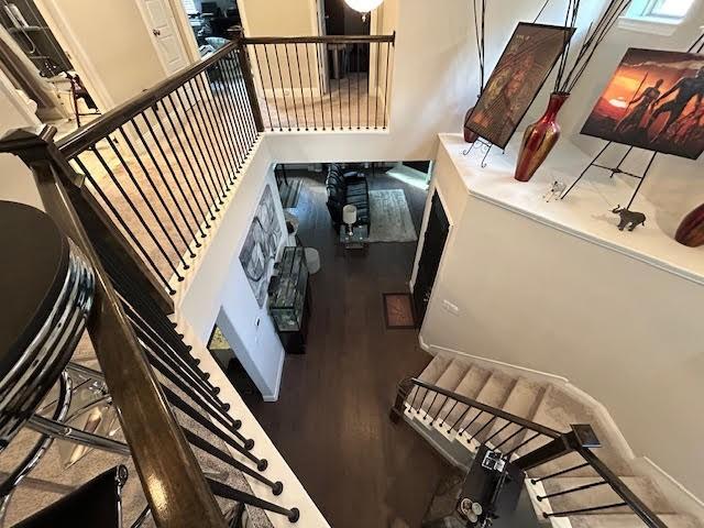 stairs featuring hardwood / wood-style floors