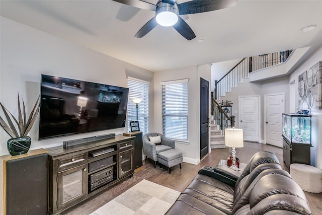 living room featuring hardwood / wood-style floors and ceiling fan