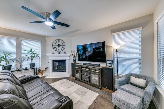 living room with dark hardwood / wood-style floors and ceiling fan