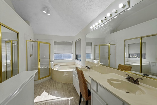 bathroom featuring hardwood / wood-style flooring, vanity, a textured ceiling, vaulted ceiling, and independent shower and bath